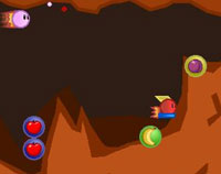Retro cave system with a pink bullet shooting through it. Fruit in orbs scattered on the cave floor.