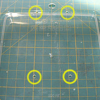 Four drilled holes for securing the A-PAC to the Tupperware box.