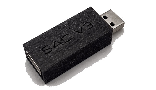 HID Remapper v3 adapter. Simple black USB stick. Female USB one end. Male the other.