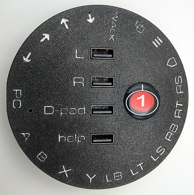 Round CATCH 22 interface in black, with white PS5 labelling for each switch and USB socket.