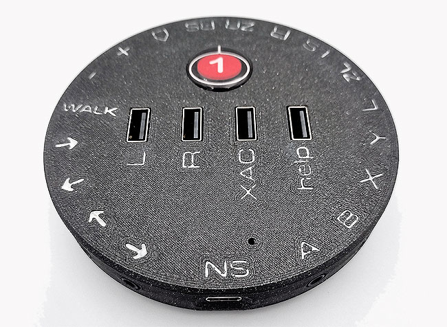 Round HID Remapper v6 in black, with labelling for each switch and USB socket.