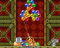 Puzzle Bobble: Coloured balls at the top, with a turret aiming at them below.