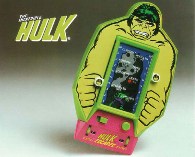 Incredible Hulk shaped hand-held electronic game from Bandai. One button control. Rotary dials and sliders for two player scoring. On off switch. RED LED light.
