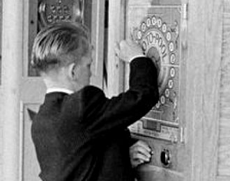 Young boy playing a one-button Rotopool wall game in the 1960s.