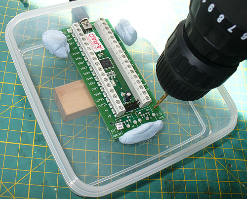 Drilling holes through the A-PAC into the housing to make fixing holes in the sandwich box.
