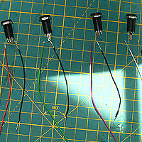 Image of four 3.5mm switch sockets laid out with the wires to attach.