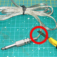 2. Cut off plug: A red circle highlights where you need to cut, just before the start of the 6.35mm plug connector.