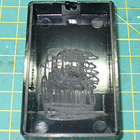 Image of the Mini-joy case, with score marks inside.